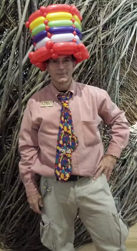 Ken Caplan holding a colorful balloon sculpture