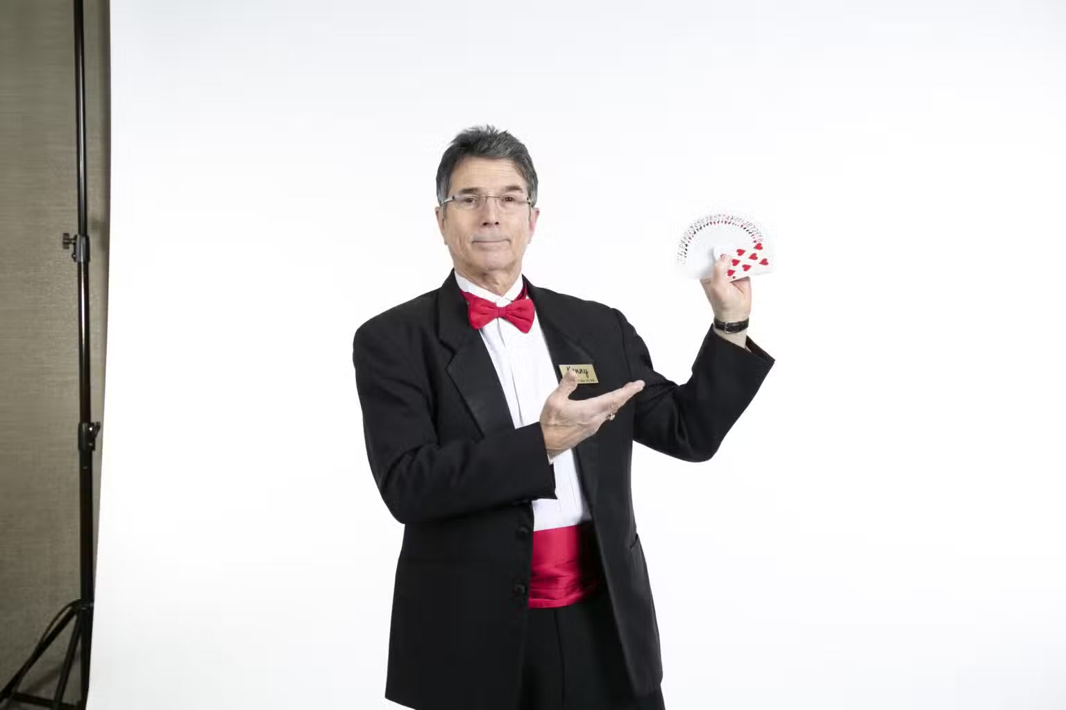 Ken Caplan holding a fan of playing cards for close-up magic
